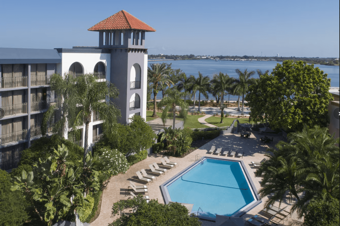 Aerial view of Courtyard Bradenton Sarasota Riverfront pool area with waterfront views